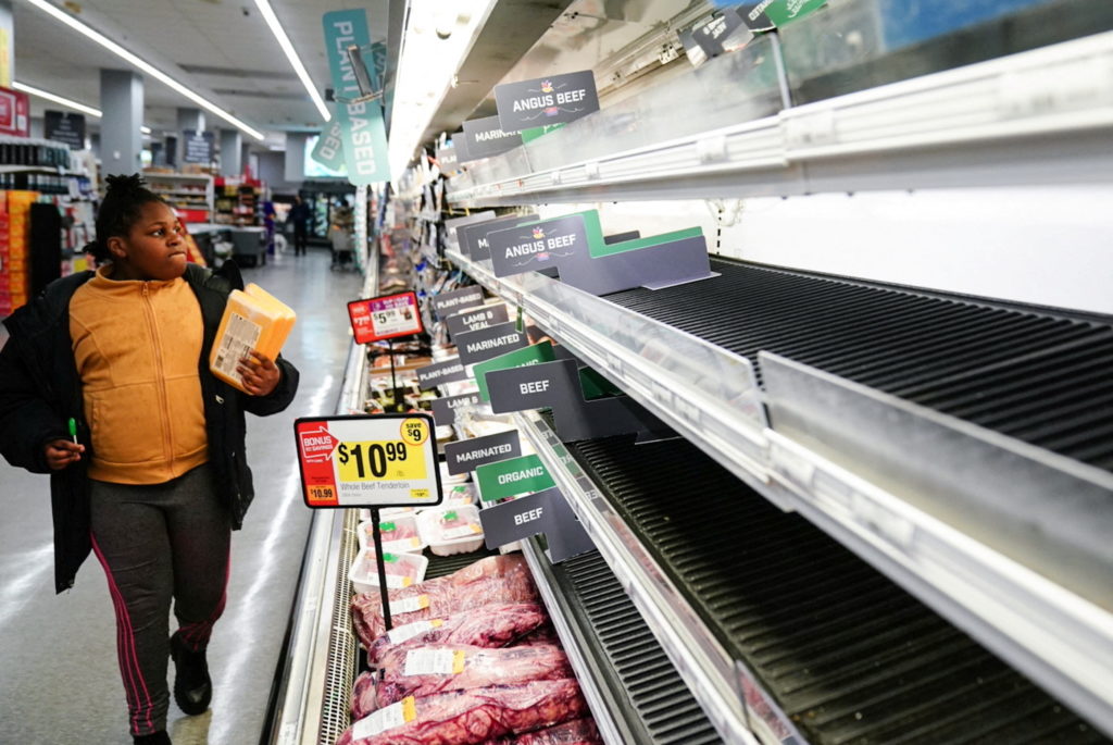 girl looking at empty grocery store aisles